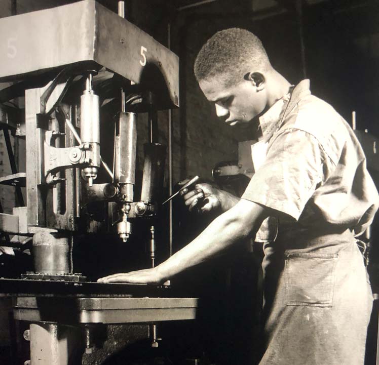 African American at factory machine